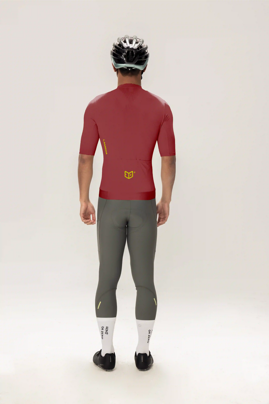 Back view of roam men jersey short sleeves purple in red with yellow logo paired with gray cycling leggings