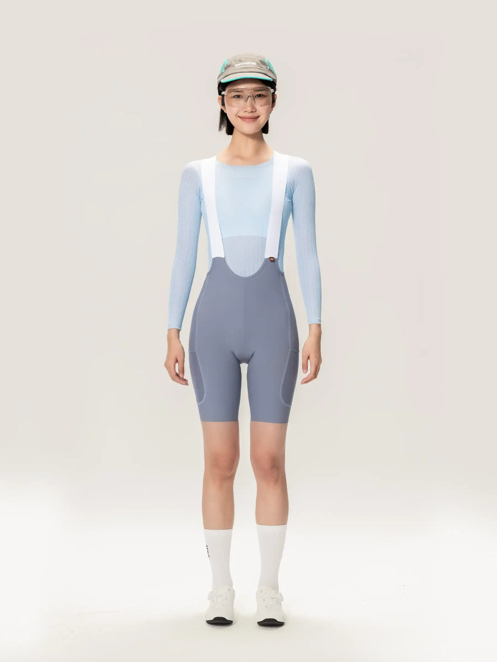 Lightweave women base layer long sleeve blue shown with light blue and gray cycling bib shorts with white suspenders and airflow mesh