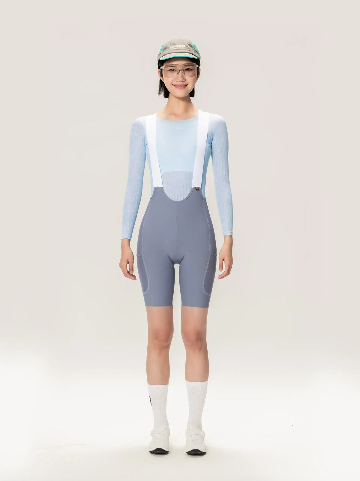 Lightweave women base layer long sleeve blue shown with light blue and gray cycling bib shorts with white suspenders and airflow mesh