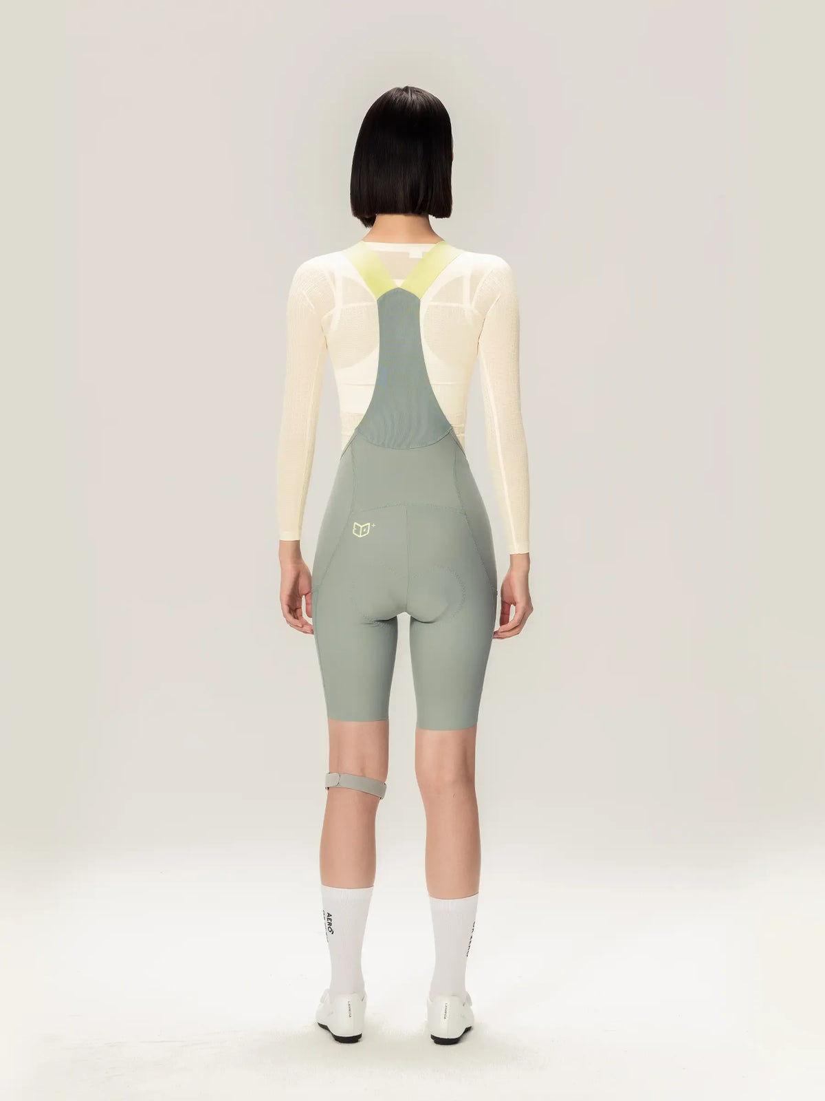 Lightweave women base layer long sleeve cream with light gray cycling jersey, translucent airflow mesh, and neon yellow straps