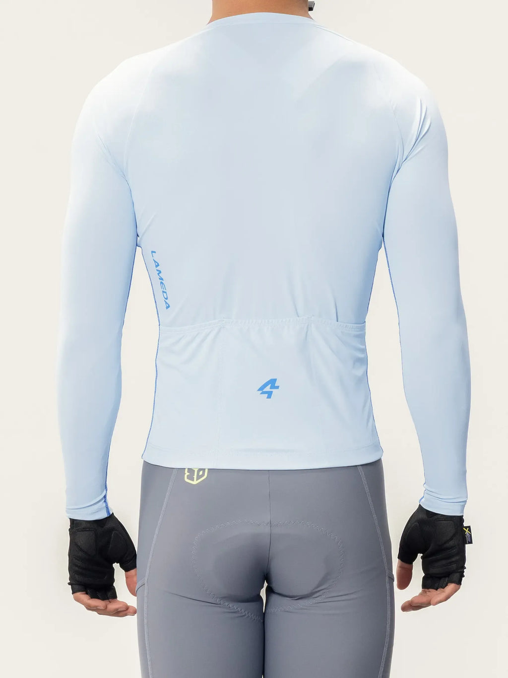 Light blue wind chaser men long sleeves cycling jersey with subtle branding and a rear pocket shown from the back