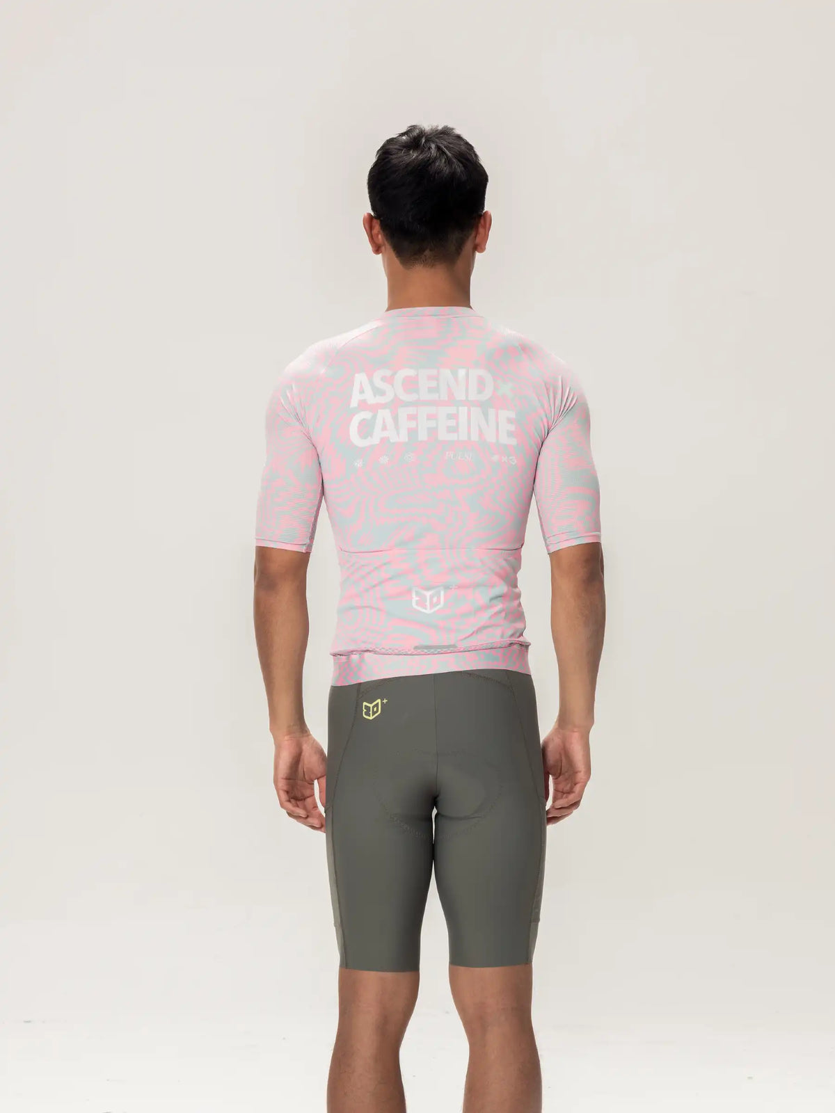 Back view of peach lameda x australian studio unisex cycling jersey with subtle geometric pattern and ascend caffeine text