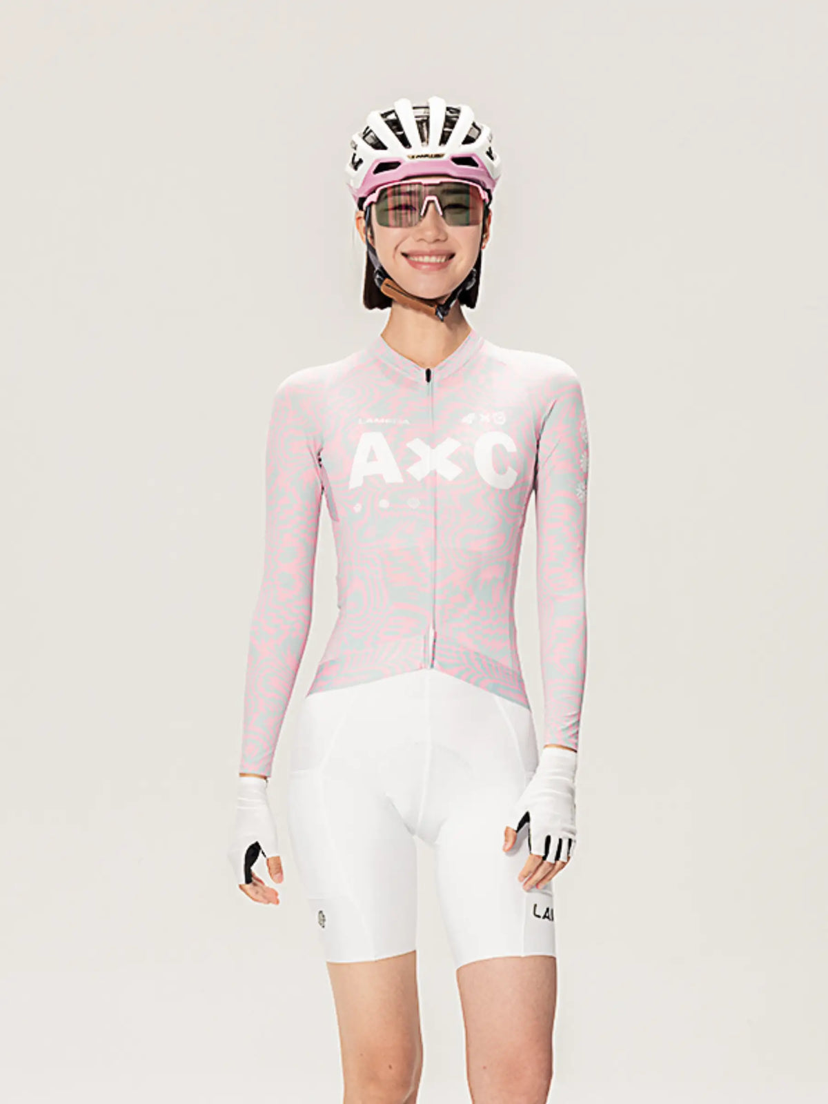 Pink and white lameda x australian studio unisex cycling jersey ls peach with axc logo on chest front view