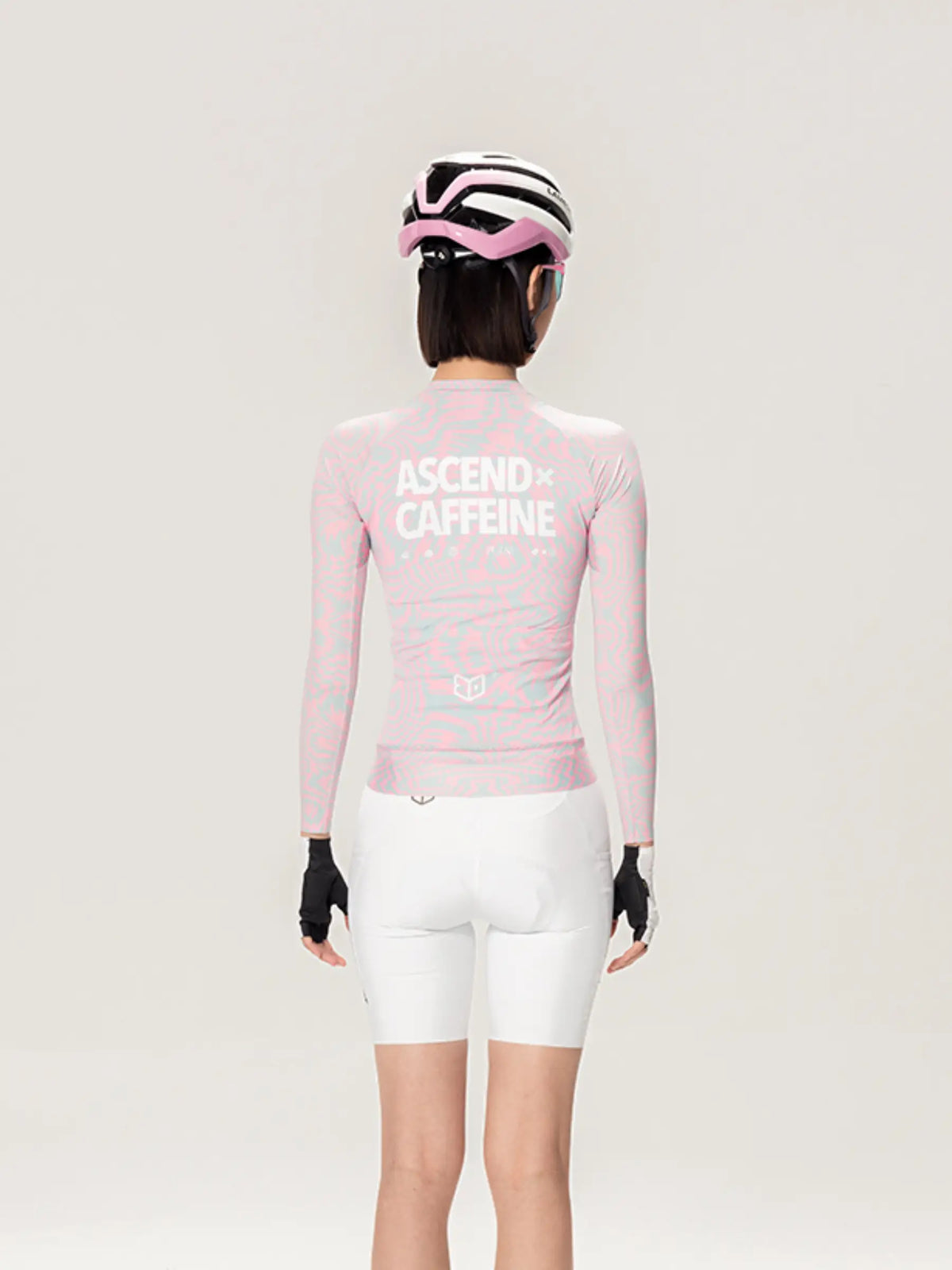 Back side of a pink long-sleeved peach cycling jersey with ascend caffeine print from lameda x australian studio unisex collection