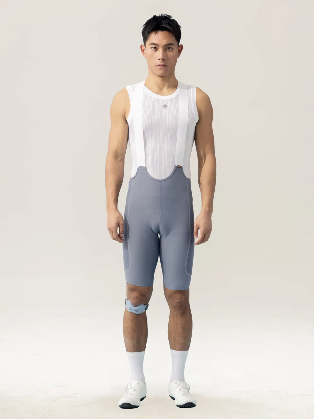 A sleek white ribbed cycling jersey paired with subtle gray breathable lameda men’s cycling bib shorts with elastic interface