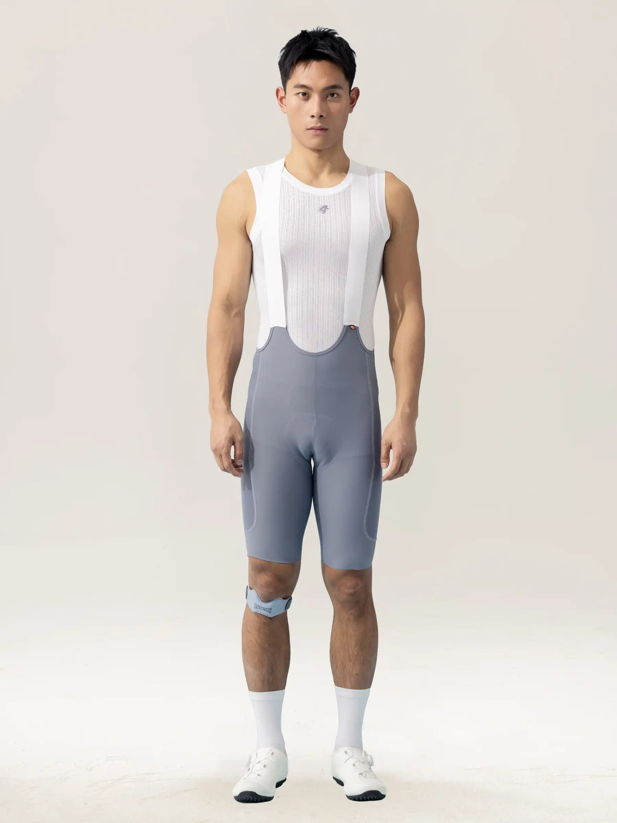 A sleek white ribbed cycling jersey paired with subtle gray breathable lameda men’s cycling bib shorts with elastic interface