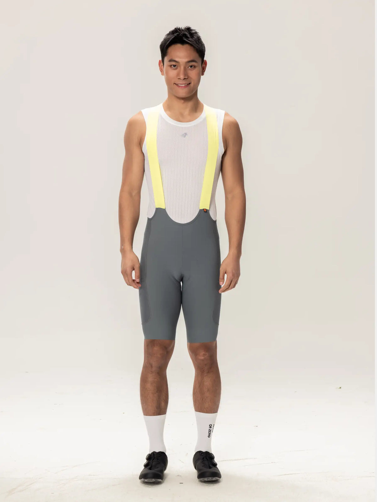 Lameda men’s cycling bib shorts gray green with bright yellow suspenders white mesh top and elastic interface