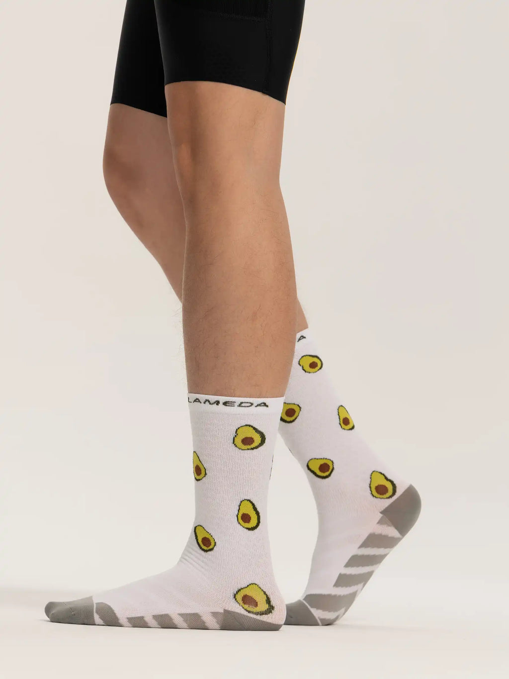 White avocado-patterned lameda cycling socks with gray heel toe accents and arch support made of fruits