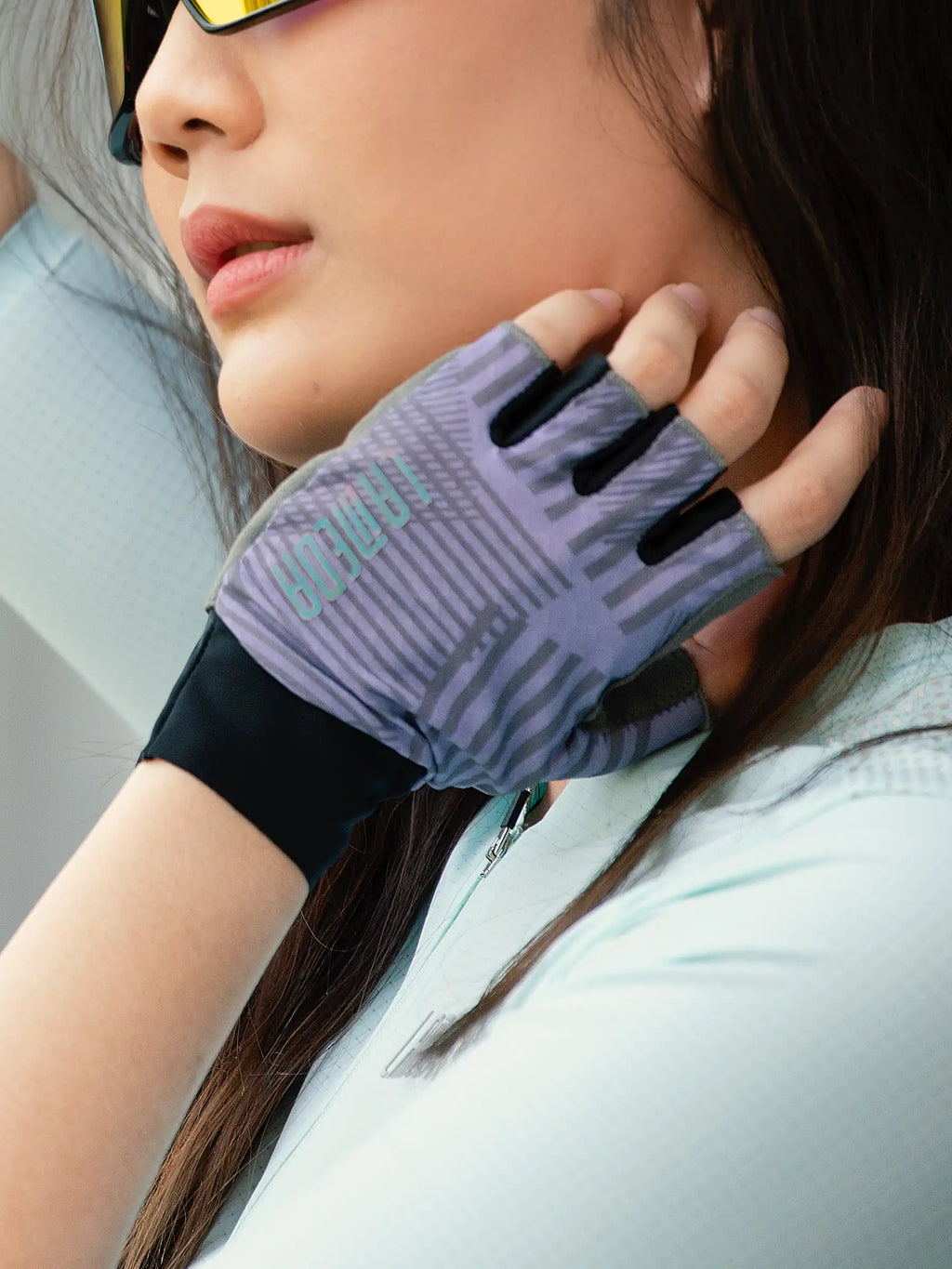Back side of purple and black half-finger cycling gloves with geometric pattern delivering essential protection
