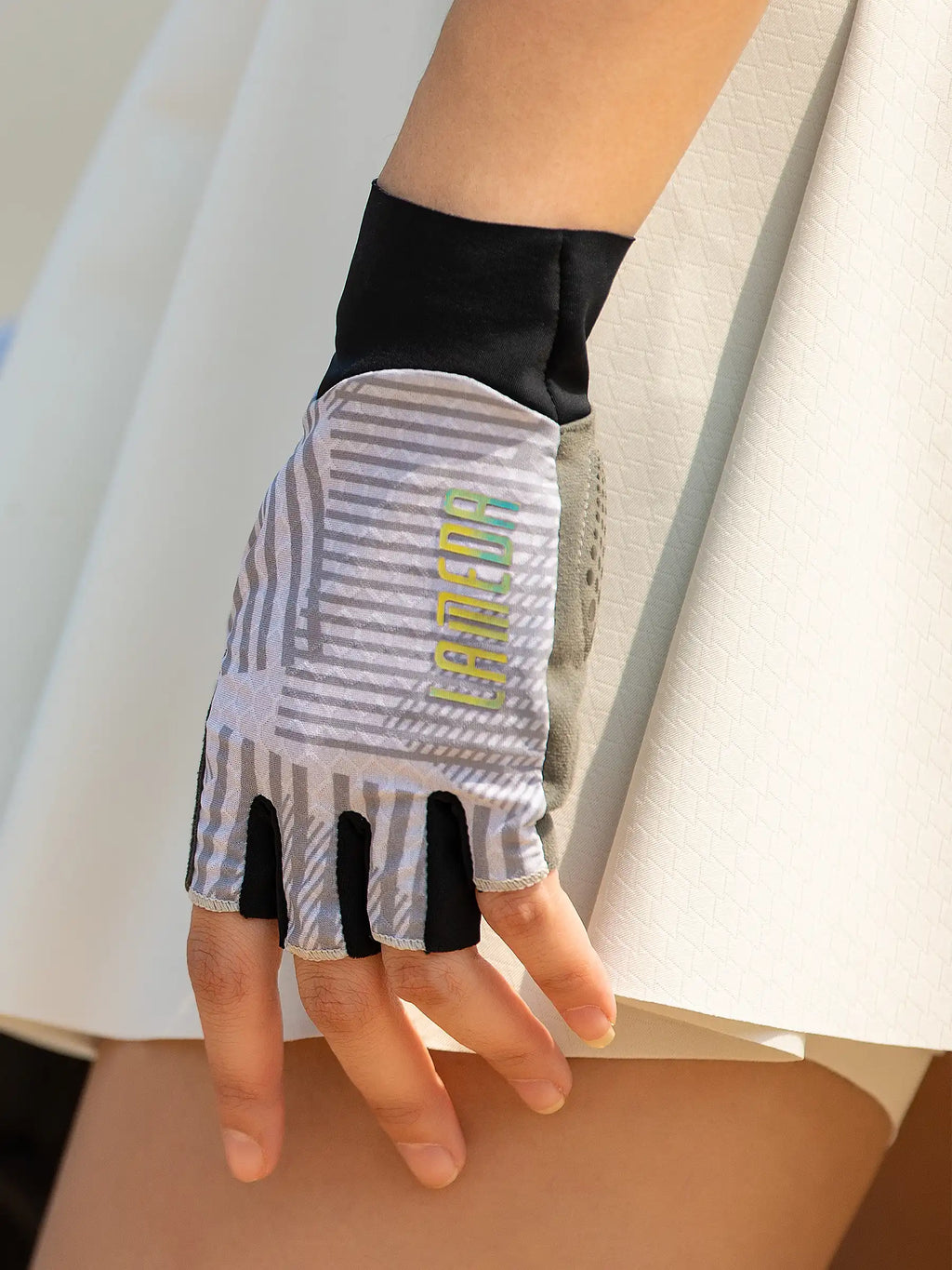 Gray and black half-finger cycling gloves with breathable mesh panel and lamco branding deliver essential protection