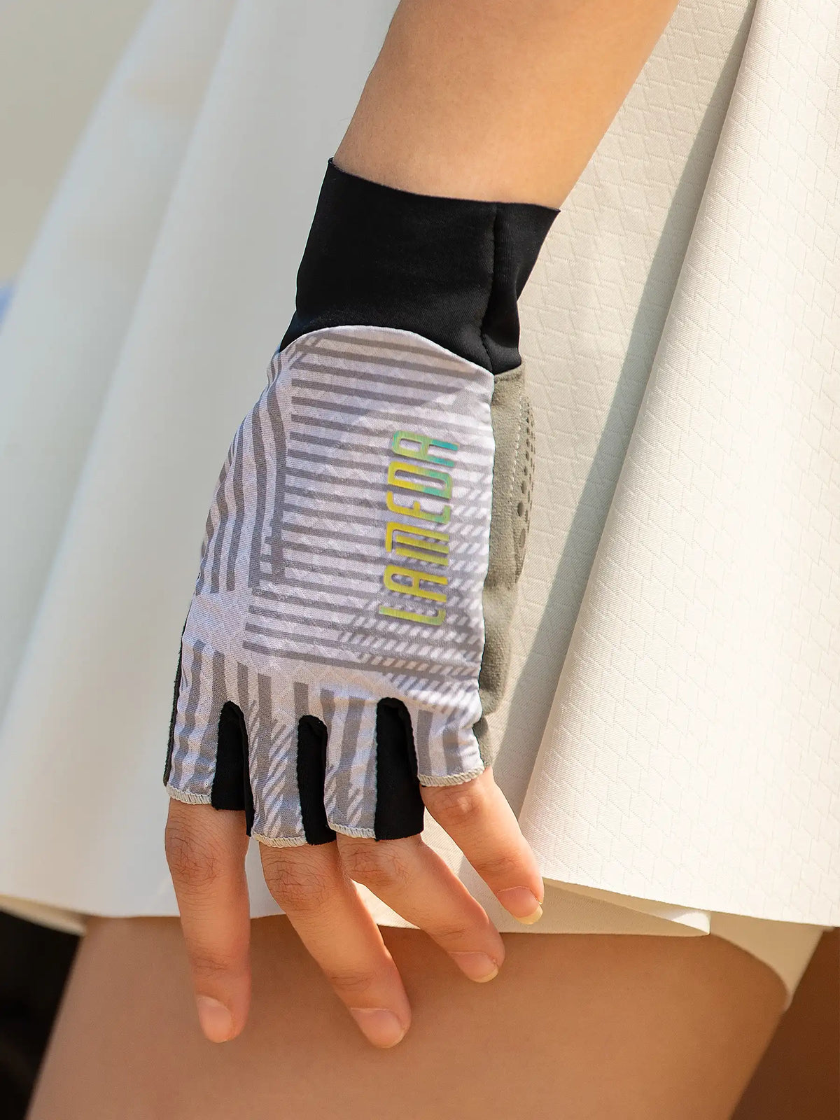 Gray and black half-finger cycling gloves with breathable mesh panel and lamco branding deliver essential protection