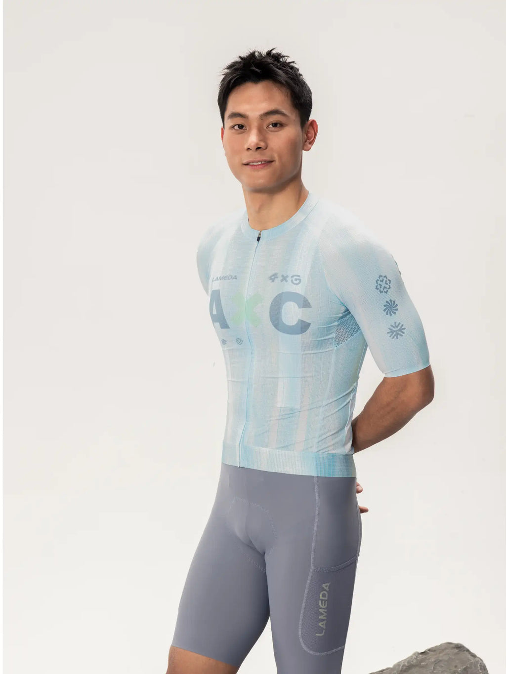 Light blue short-sleeved lameda x australian studio unisex cycling jersey with subtle pattern paired with gray shorts