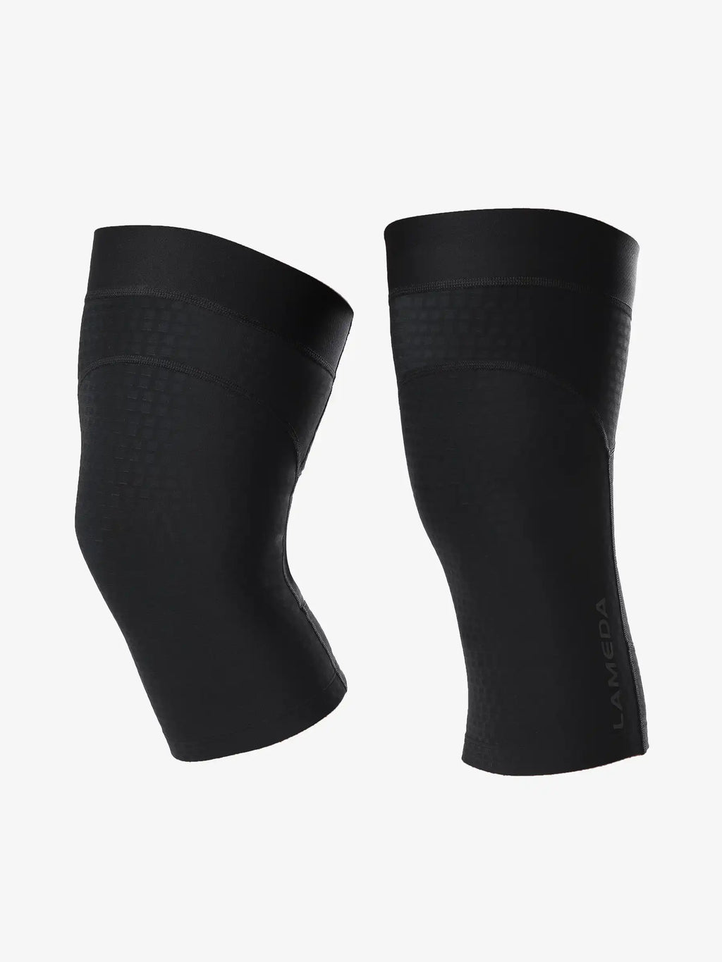 Black lameca knee sleeves with sleek form-fitting design and subtle branding ideal as lameda cycling leg warmers
