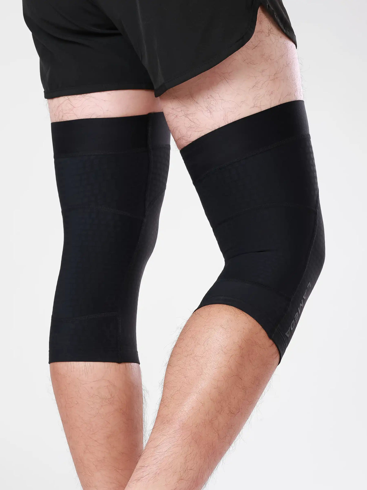 Black lameda cycling leg warmers with sleek, form-fitting knee support sleeves designed for cycling leg comfort