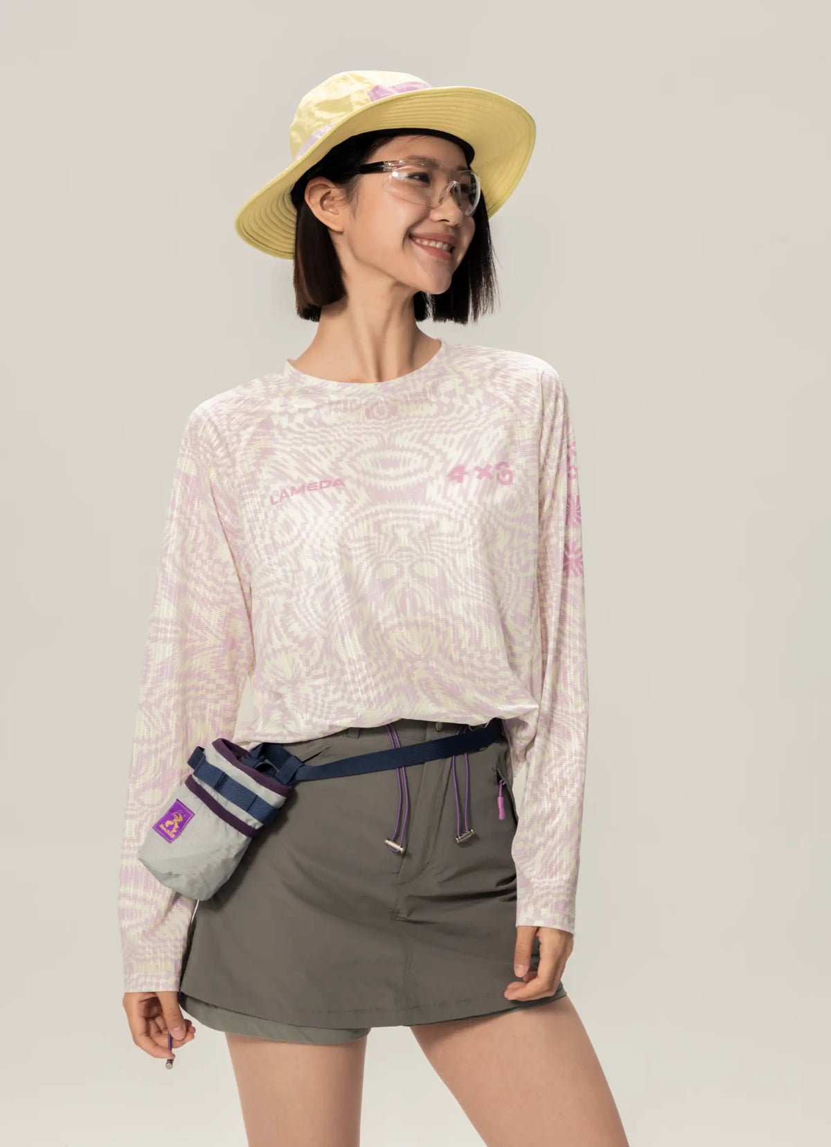 A light gray a x c unisex lightweight cycling long-sleeve t-shirt with pink embroidery ideal for daily commutes