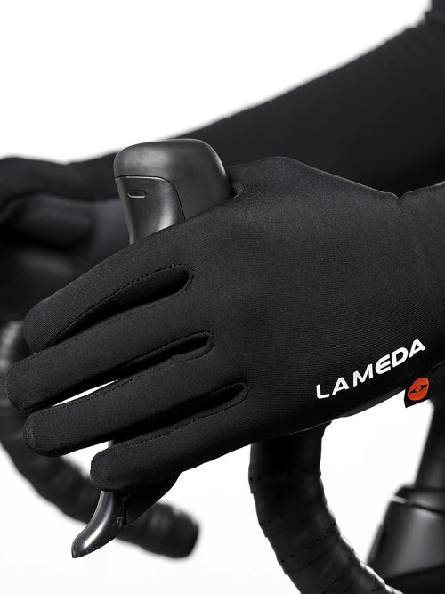 Back side of black 2064 thermal bike gloves with elastic interface, fleece lining, white branding, and orange wrist logo