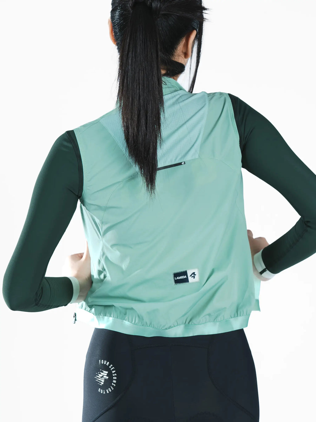 Nova women’s cycling windproof vest in mint green lightweight recycled polyester with black zipper and brand label on back side