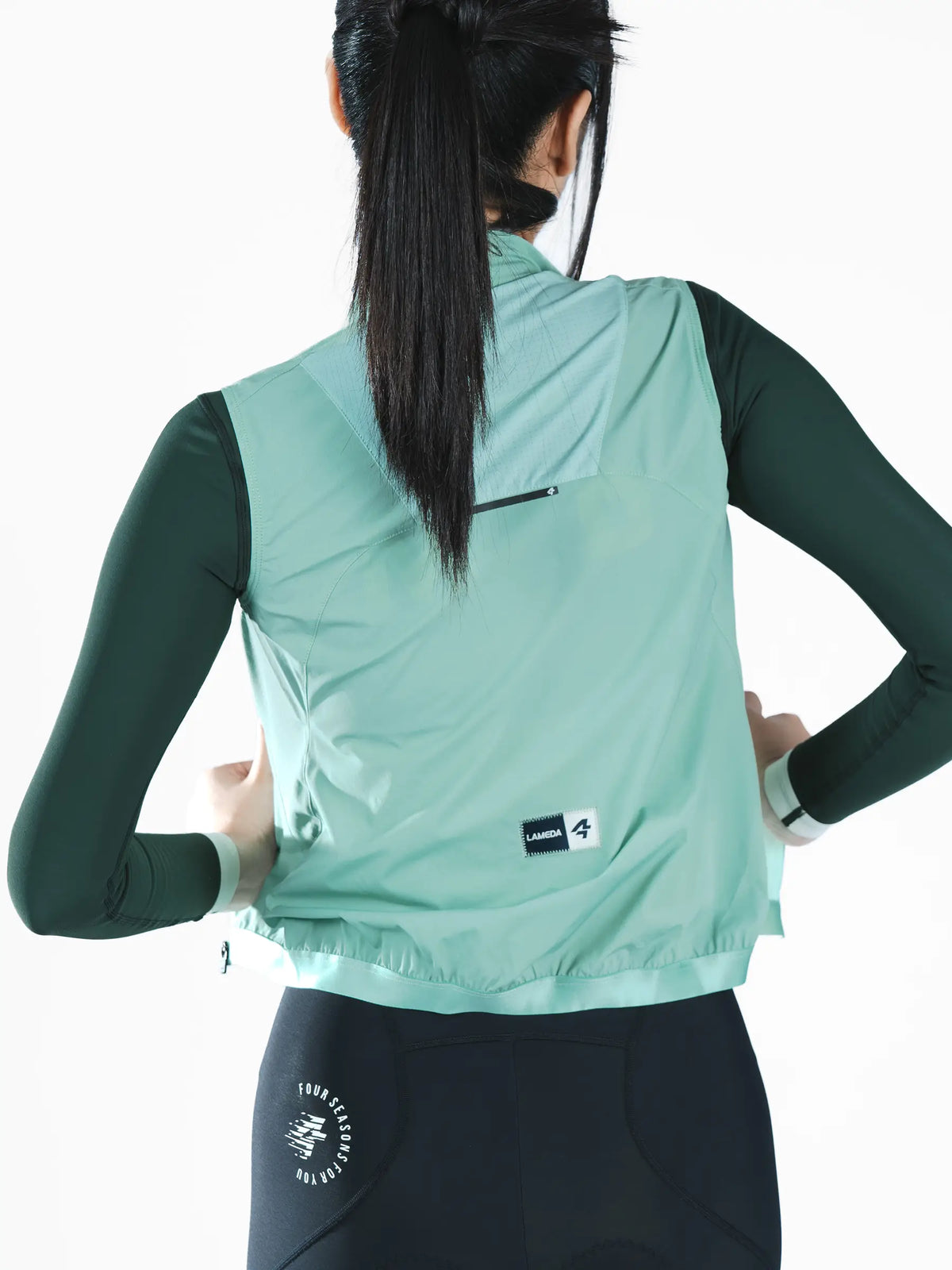 Nova women’s cycling windproof vest in mint green lightweight recycled polyester with black zipper and brand label on back side