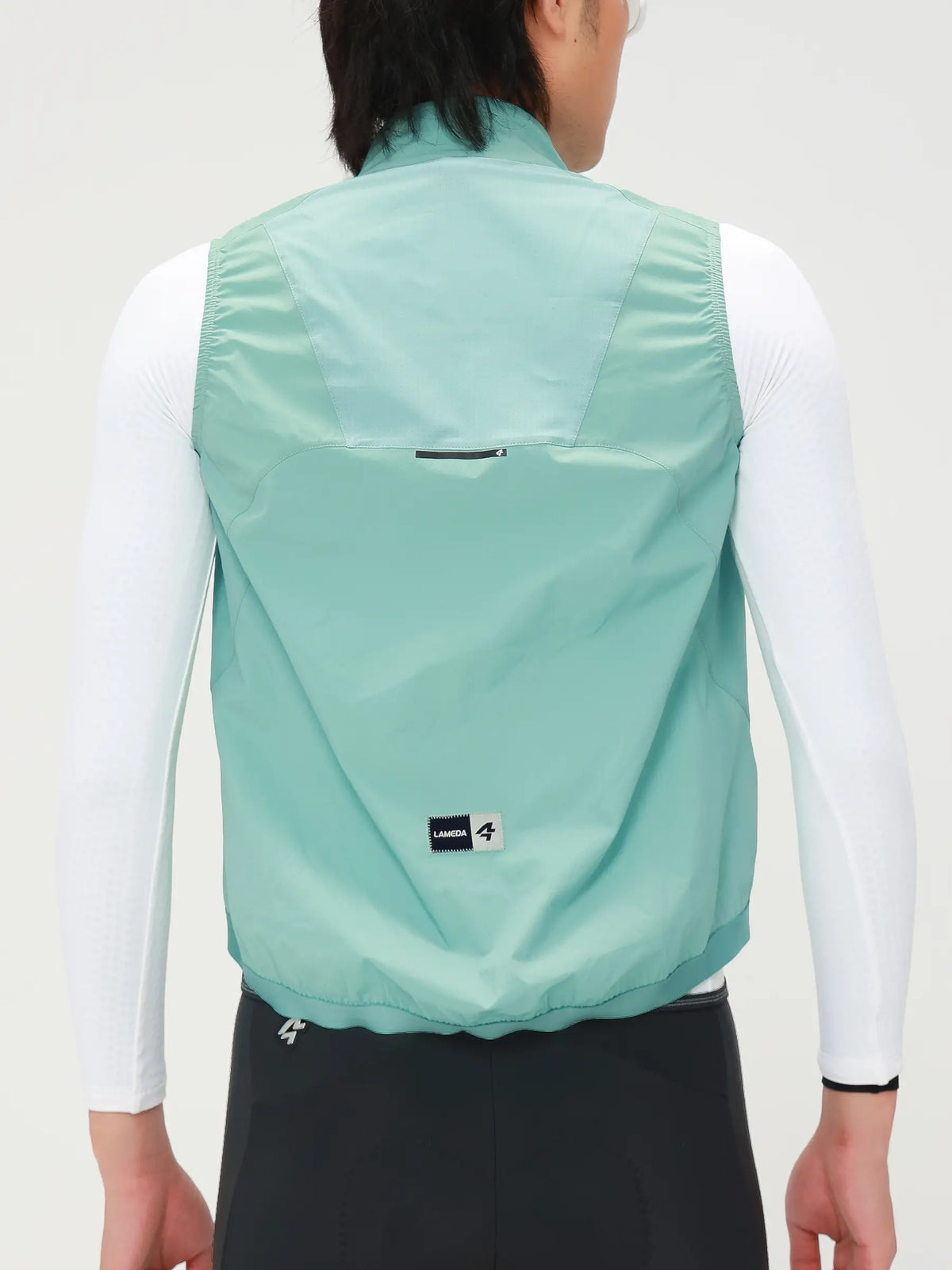 Nova men’s cycling windproof vest in light mint green made from recycled polyester and sorona t800 yarn, back view