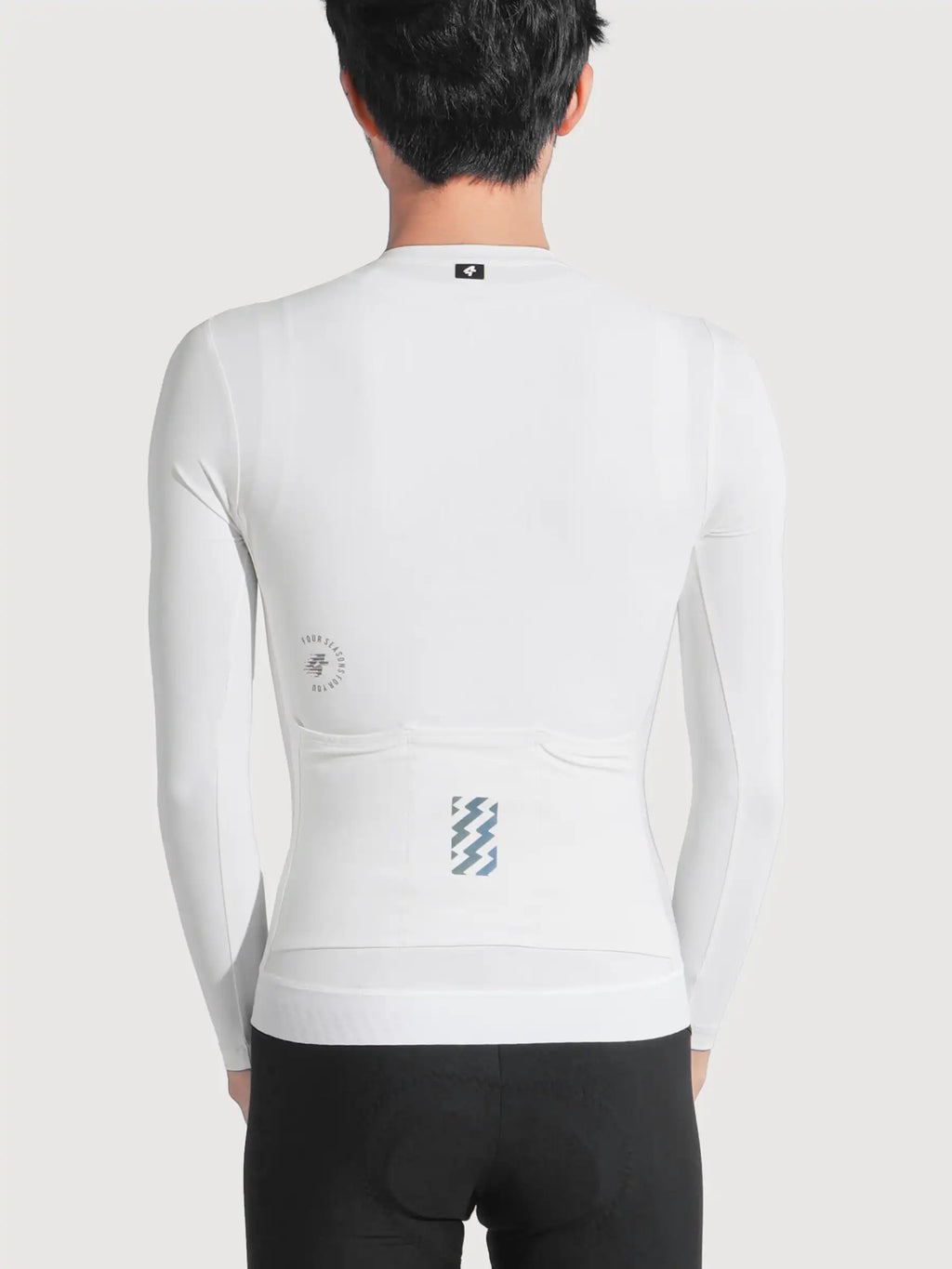Back side of lameda freedom white cycling jersey with subtle blue and gray geometric pattern on the long-sleeved pocket