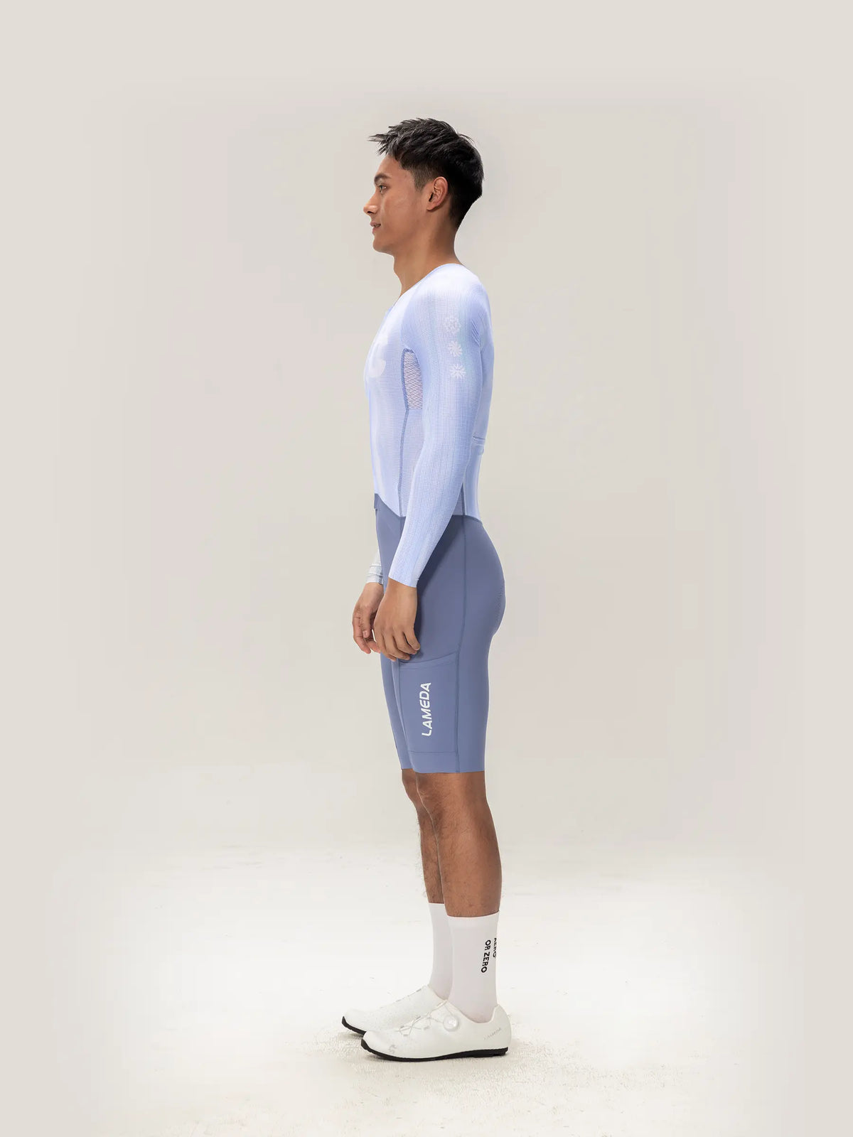 Lameda A*C men skinsuit long sleeves in ice purple featuring light blue cycling jersey with mesh panels and gray shorts