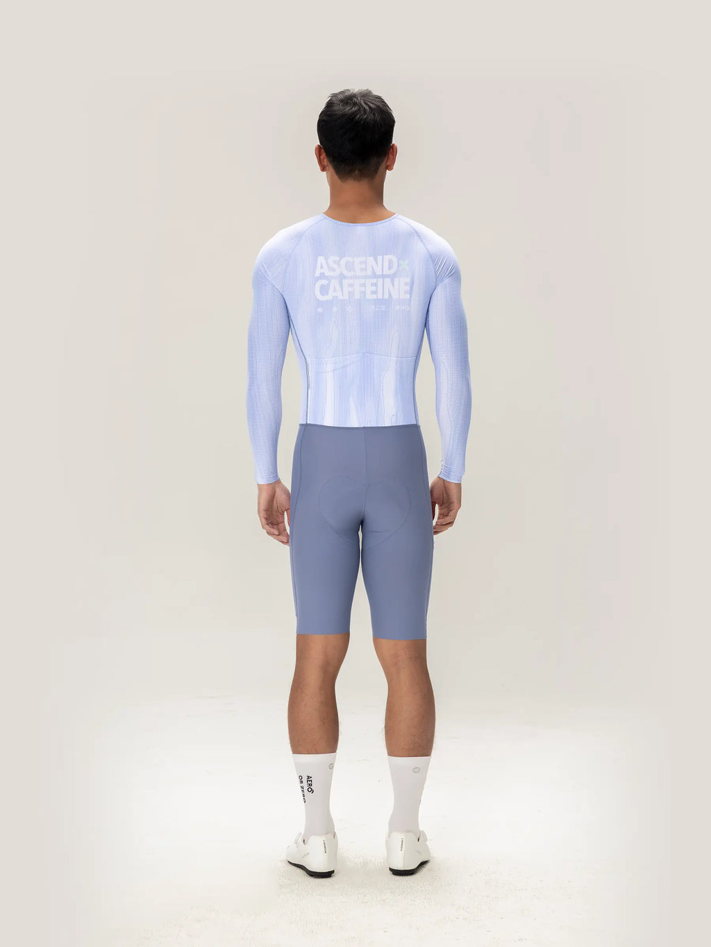Back view of light blue long-sleeved cycling jersey with ascend caffeine print in lameda a c men skinsuit ice purple