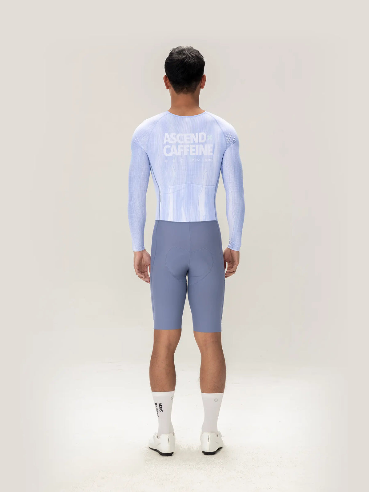 Back view of light blue long-sleeved cycling jersey with ascend caffeine print in lameda a c men skinsuit ice purple