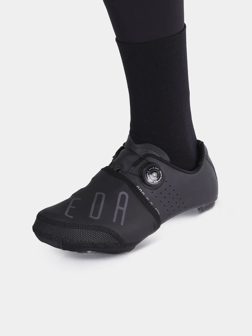 Black cycling shoe with perforated breathable upper and aerodynamic design featuring shoe toe caps for windproof use