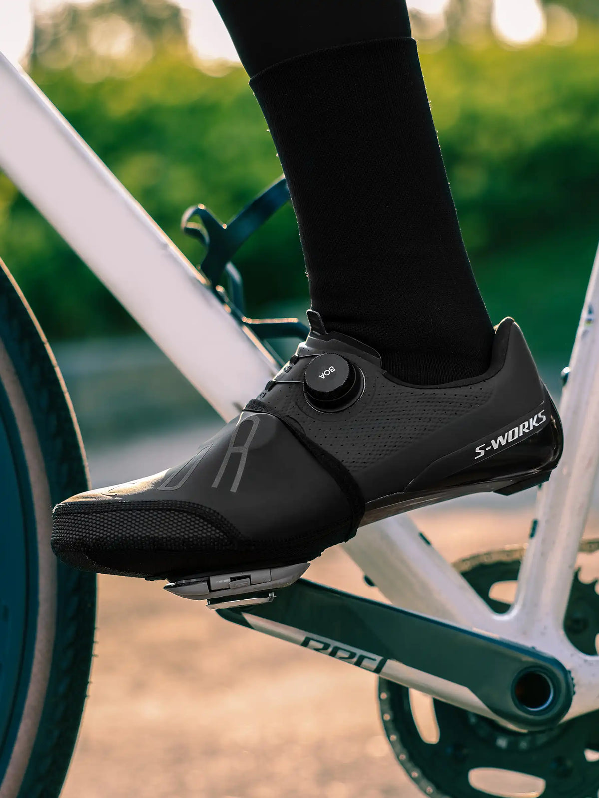 Black s-works cycling shoe with carbon fiber sole featuring aerodynamic design and shoe toe caps for windproof use