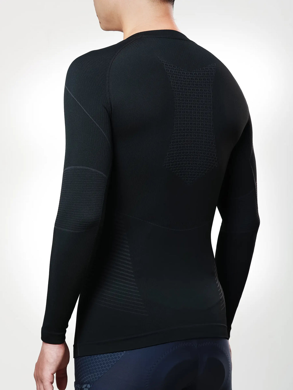 Men’s black long-sleeved compression top with seamless construction and textured panels for cycling compression and muscle support