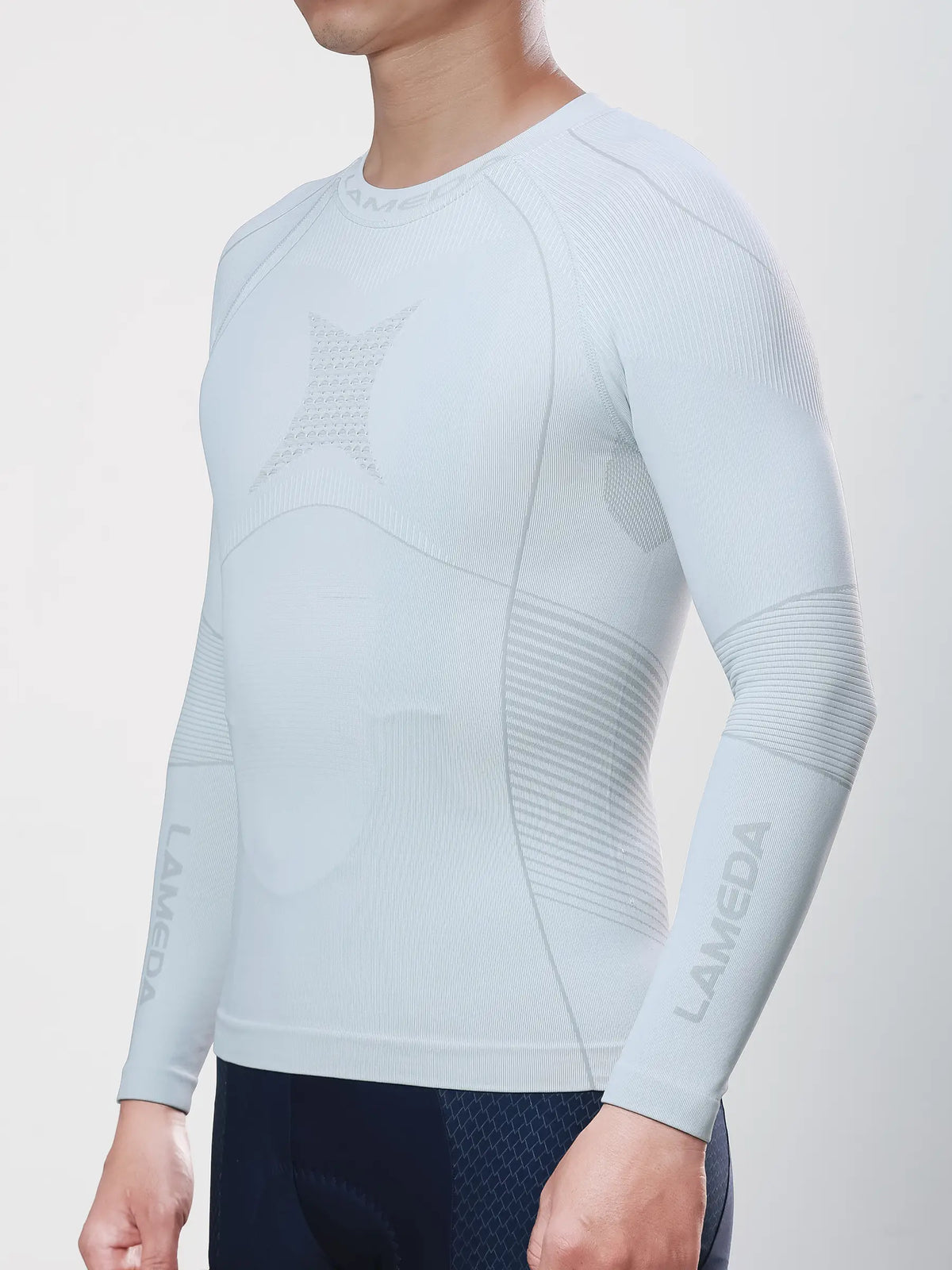 Men’s grey compression top with subtle texture and logo on sleeve made from bamboo charcoal fiber for cycling compression and muscle support