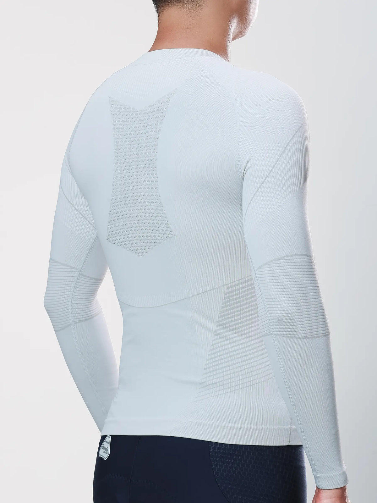 Men’s grey compression top with textured mesh back and ribbed arms made from bamboo charcoal fiber for muscle support