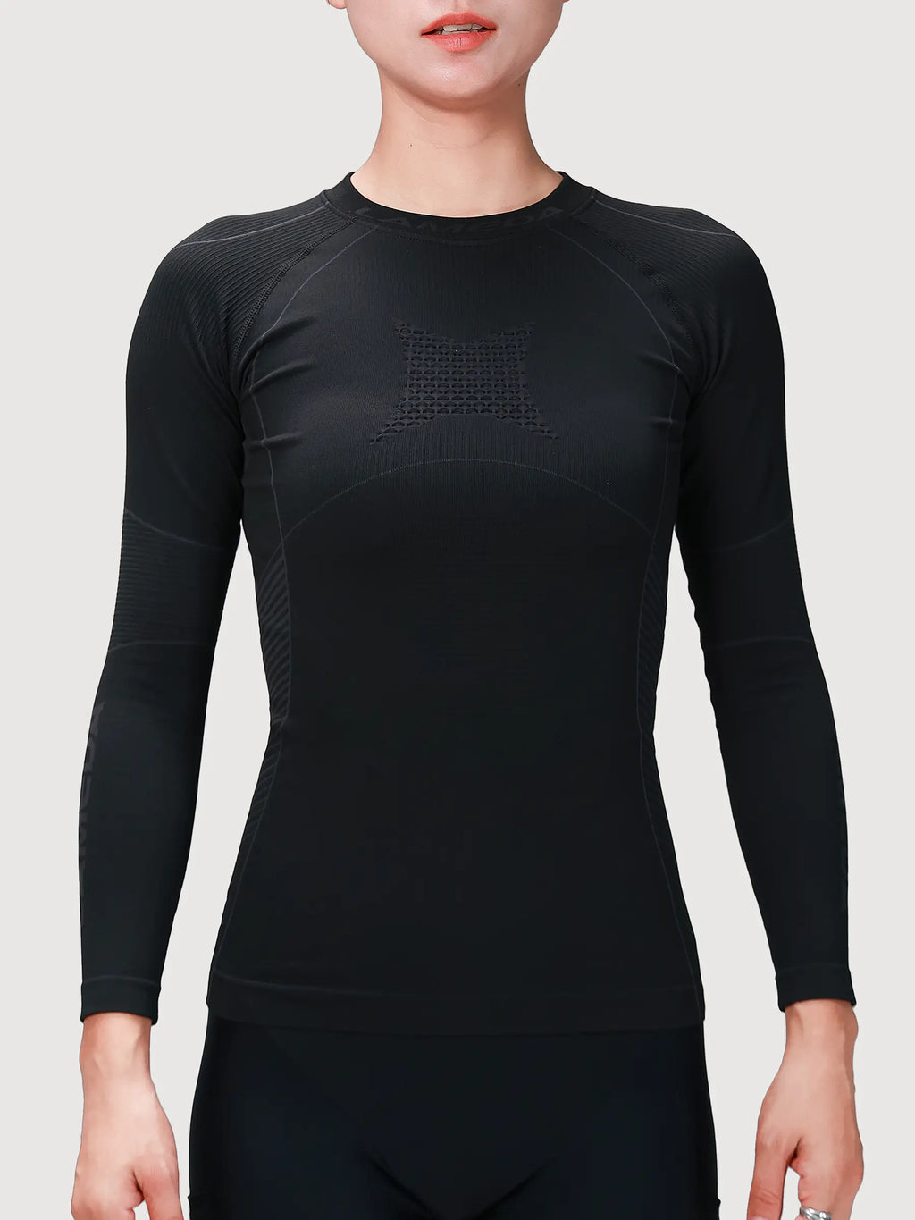 Women’s compression top in black featuring bamboo charcoal fiber with textured paneling for cycling compression and muscle support