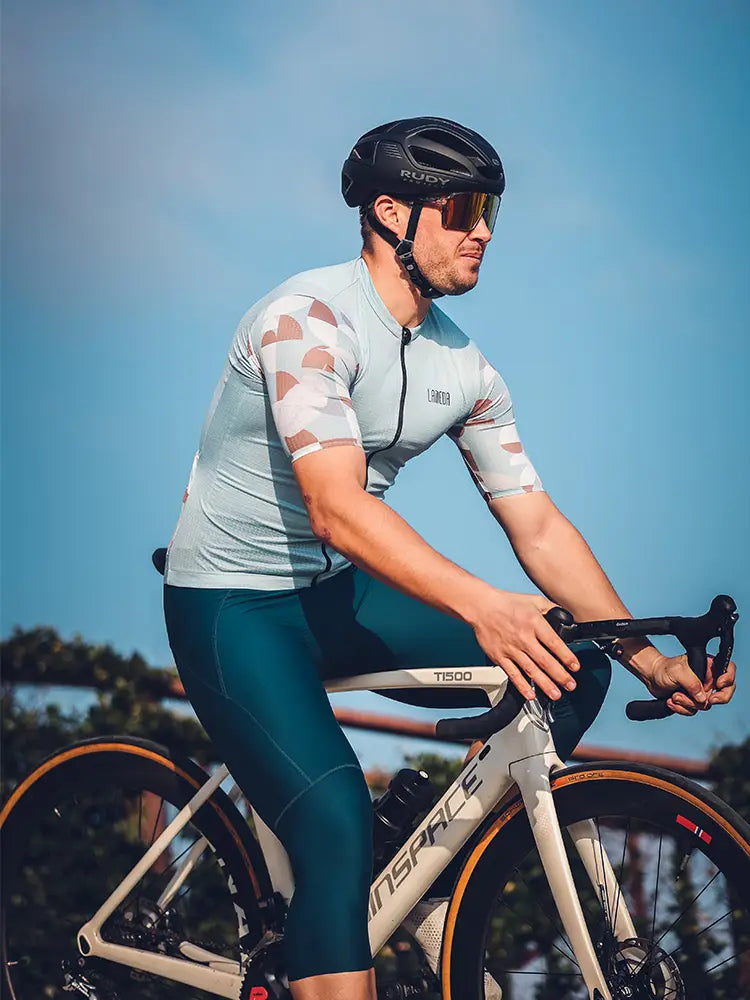 The trending men’s cycling jersey in green features a relaxed fit and is shown with a sleek t1500 bicycle frame