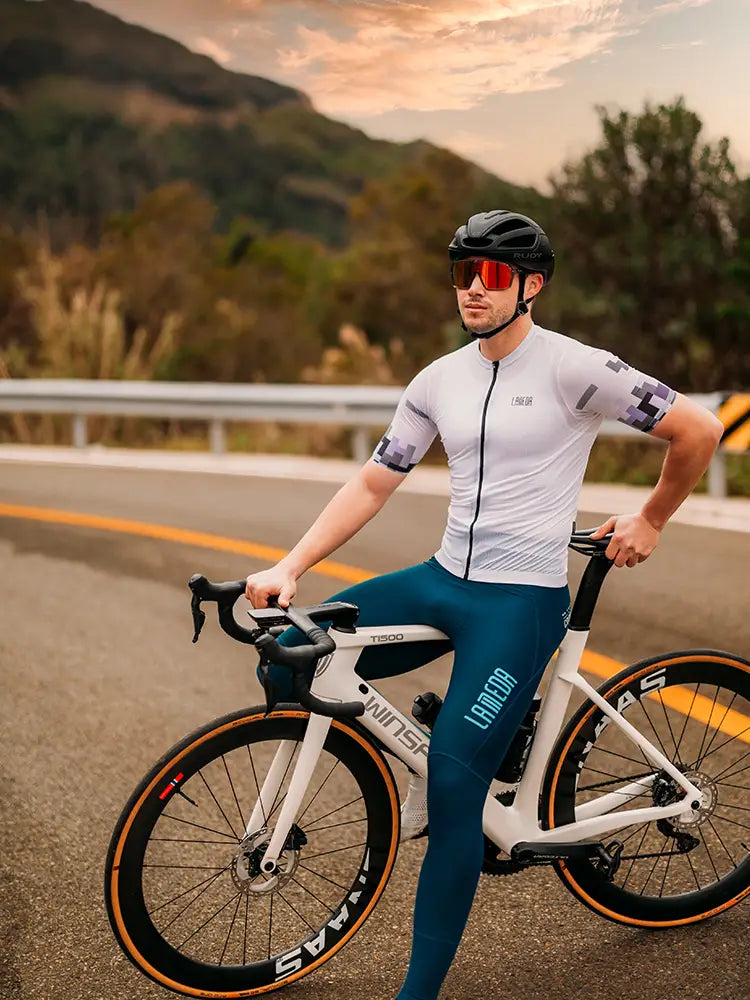 White road bike with black handlebars and orange-accented tires paired with a trending men’s cycling jersey with relaxed fit