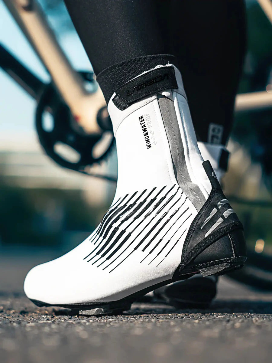 White warm shoe cover with sleek black diagonal stripes designed for cycling shoe covers protecting against light rain and road splashes