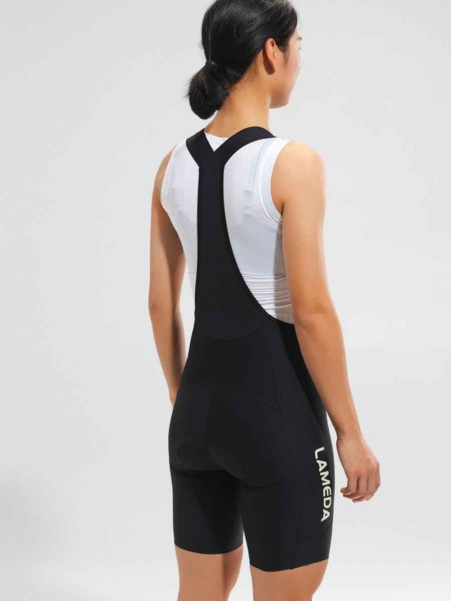 Women’s elite bib shorts 2025ssxx488 in black with white panels featuring anti-slip leg grippers and breathable mesh waistband