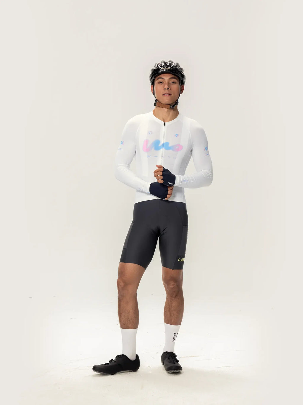 White long-sleeved lameda women’s cycling jersey with pastel blue and pink logo accents for women’s cycling jersey use