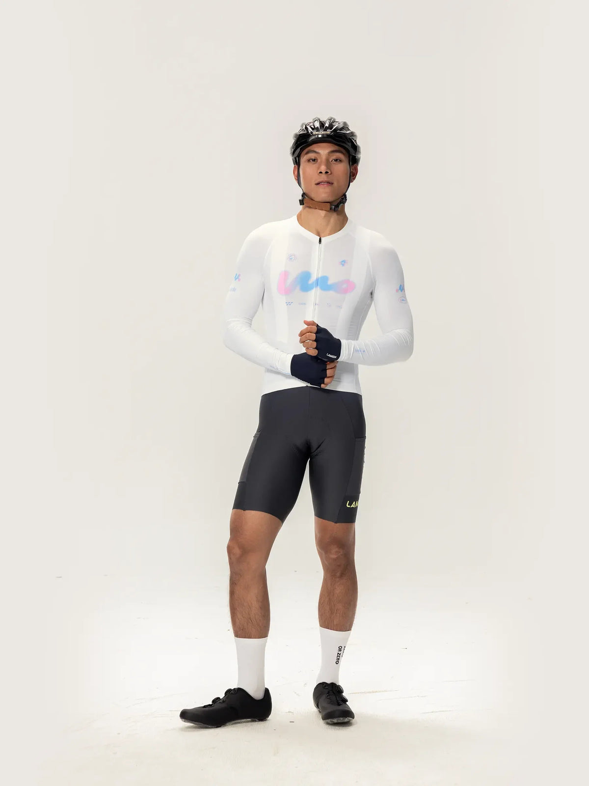 White long-sleeved lameda women’s cycling jersey with pastel blue and pink logo accents for women’s cycling jersey use
