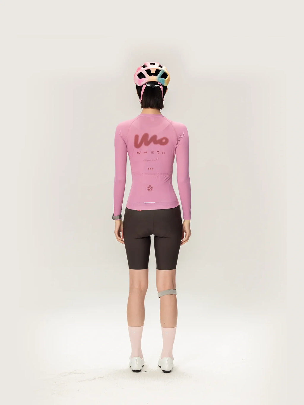 Back view of pink lameda women’s cycling jersey long sleeve with stylized logo perfect for outdoor cycling