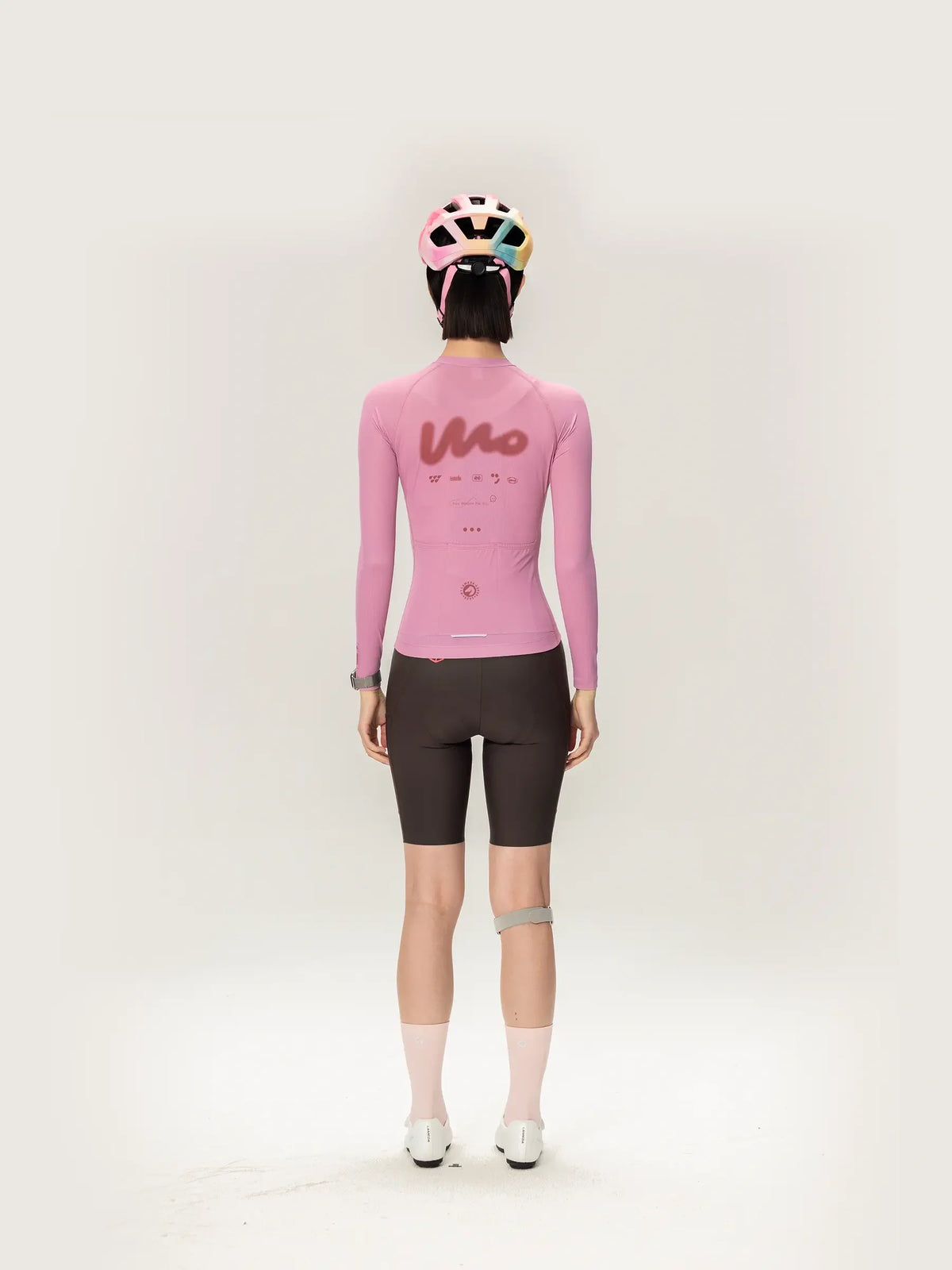 Back view of pink lameda women’s cycling jersey long sleeve with stylized logo perfect for outdoor cycling