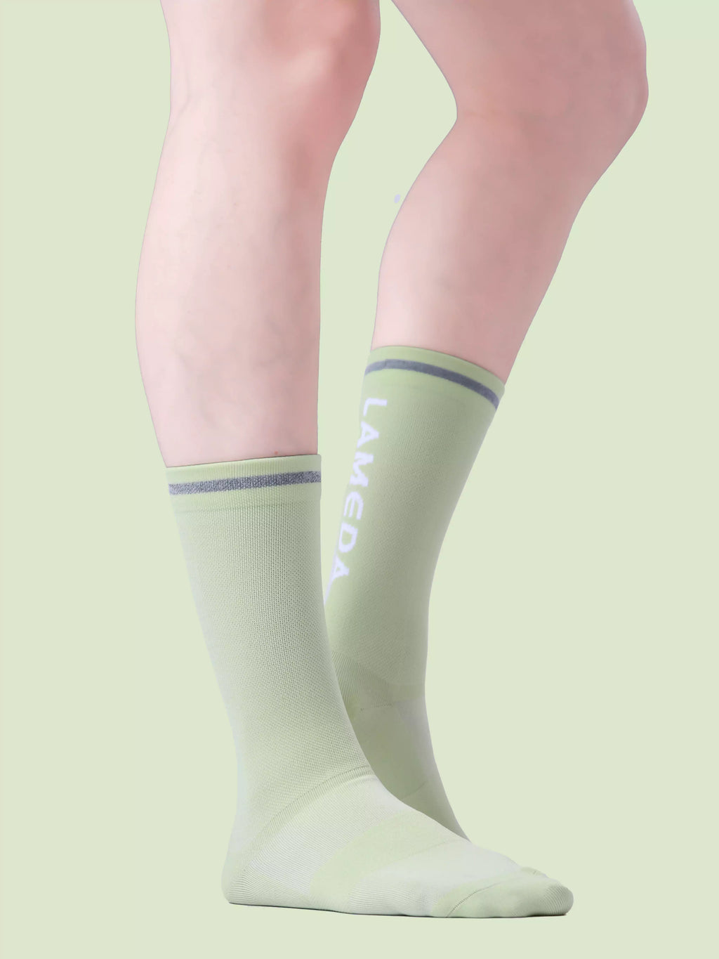 Mint green reflective sports socks 7305 featuring arch support seamless toes and gray ribbed cuffs by lameda